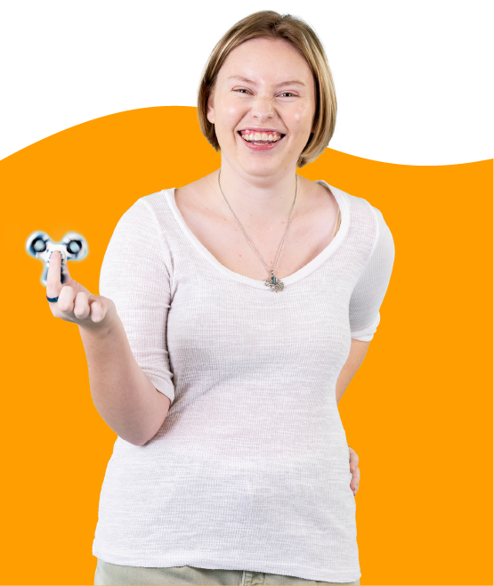 A teenage girl holding fidget spinner laughing