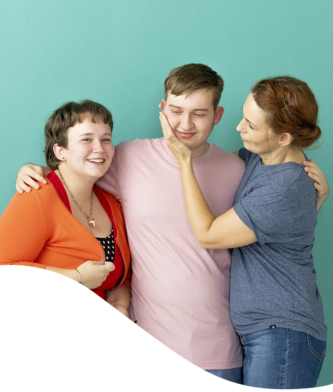 Son, daughter, and Mother hugging smiling