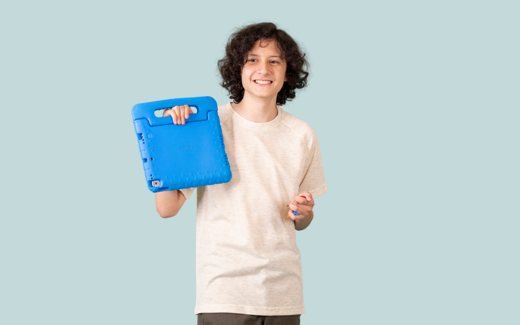 A teen boy showing off his tablet