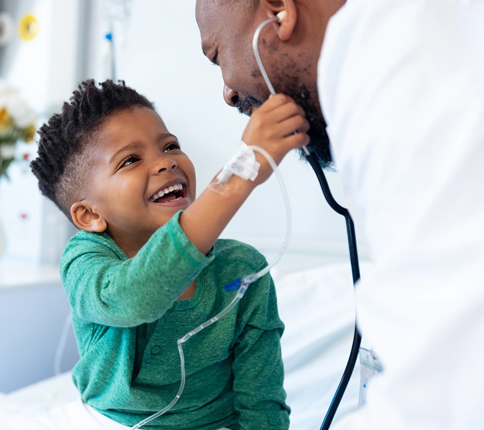 A Kid with his doctor laughing